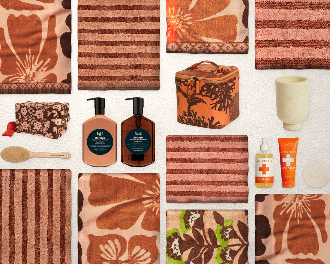 Terracotta bathroom edit flat lay with towels, bath mats and basin products at House Warming