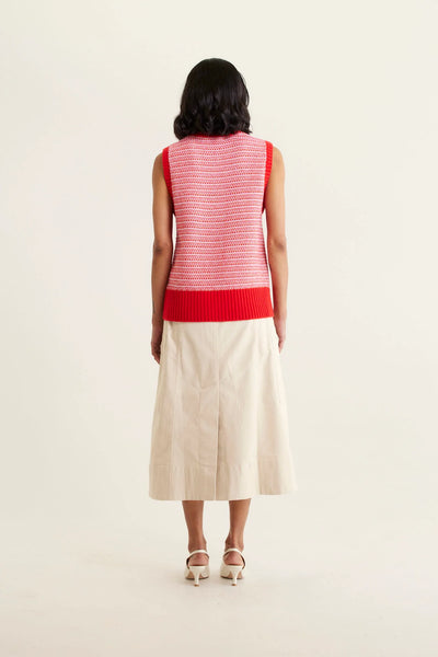 woman facing the back wearing Houston Merino Cashmere Vest - Red and beige skirt
