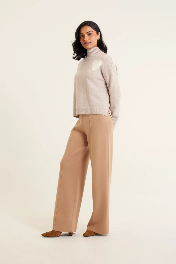 woman wearing Ronnie Merino Cashmere Polo - Beige and brown pants