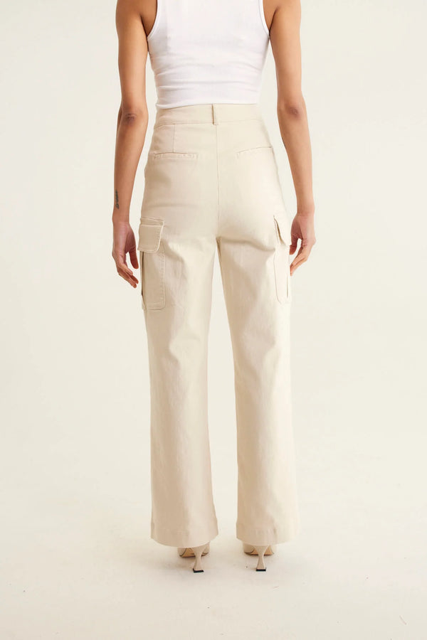 woman faicng the back wearing sleeveless top in white and Whitney Cotton Drill Pant - Pebble