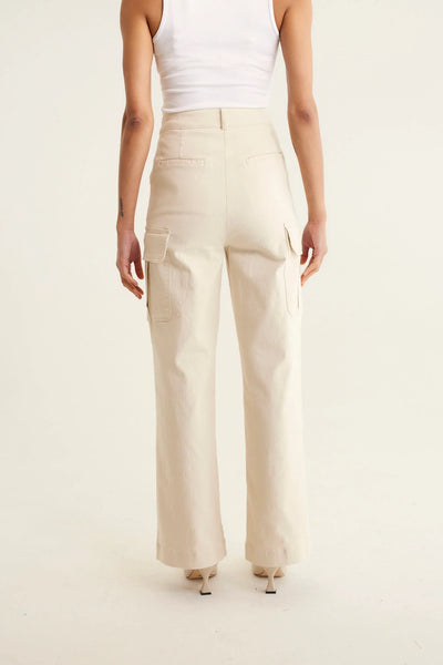 woman faicng the back wearing sleeveless top in white and Whitney Cotton Drill Pant - Pebble
