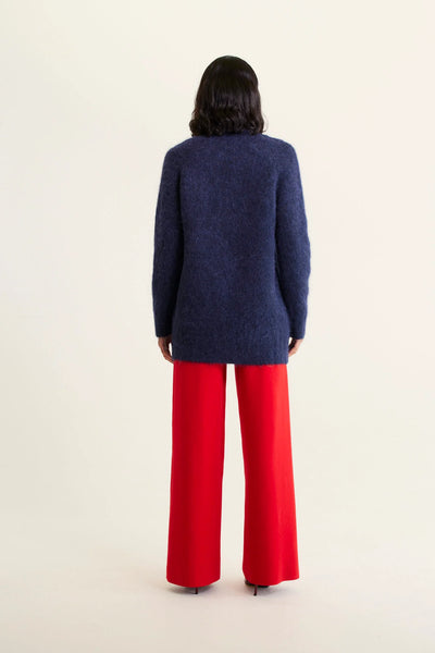 woman facing the back wearing Williamsburg Cardi - Navy and red pants