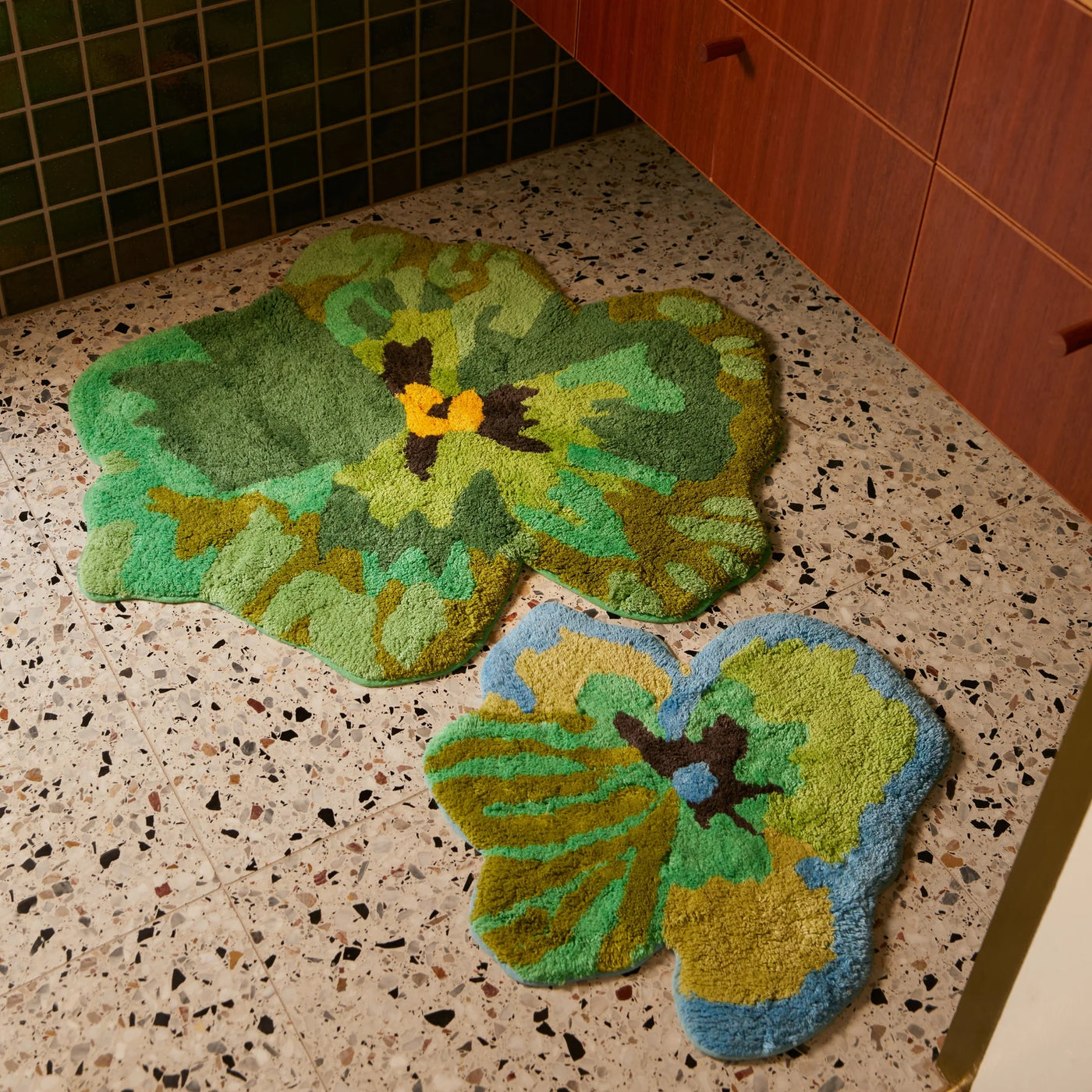 green pansy and viola green small bath mat placed on terrazzo bathroom floor