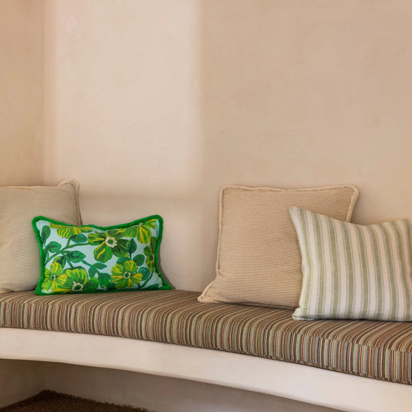 big brown, green floral, and linear green cushion