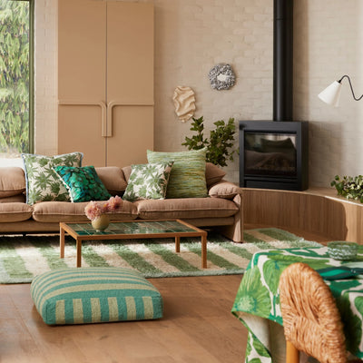 Living room with Flannel Flower Khaki 60cm Cushion placed in brown sofa 