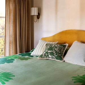 Bed with green floral plant design and Linear green and floral green cushion