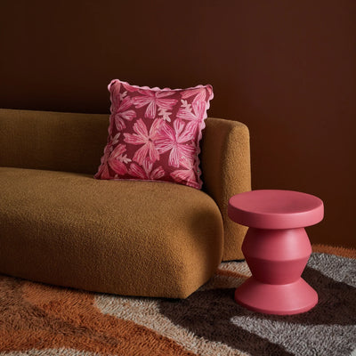 Brown sofa with mave rose cushion