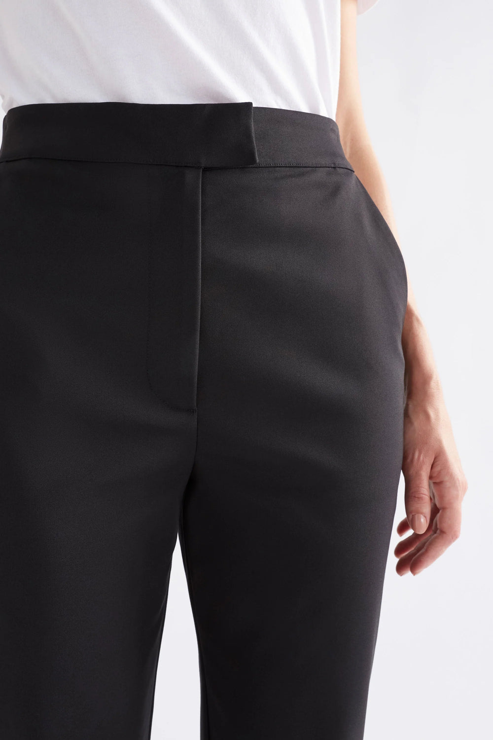 Woman wearing white shirt and black pants