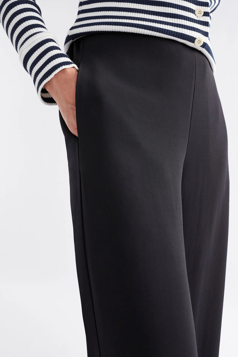 Woman wearing long sleeve stripe top and black pants