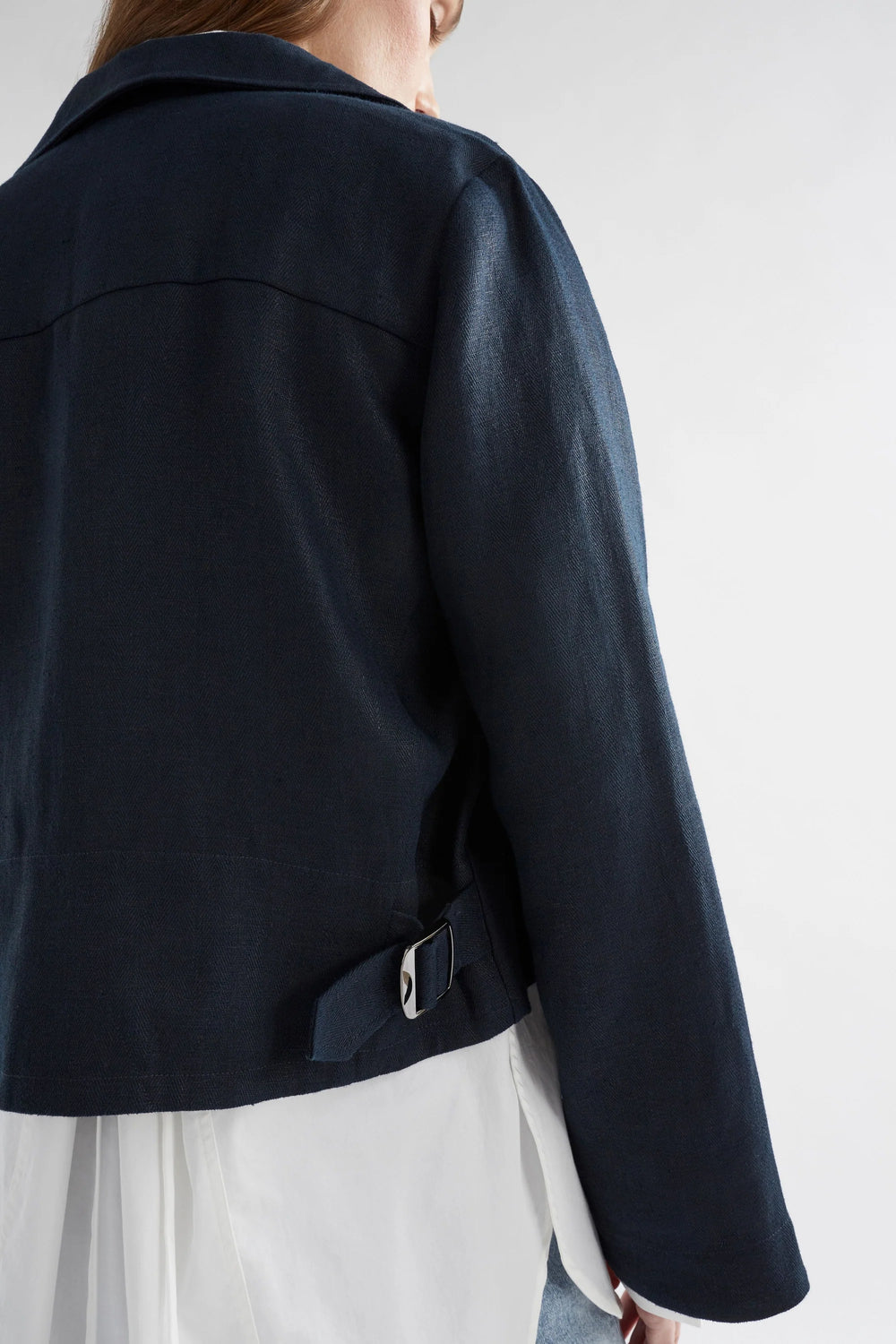 woman wearing light denim pants, white  long sleeve bottom down short and njord jacket in ink colour