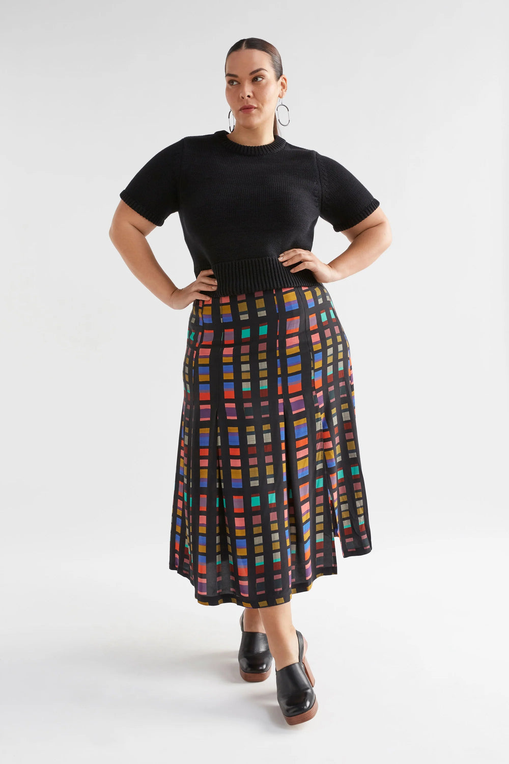 Woman wearing Black Lift Knit Top and Multi-coloured skirt