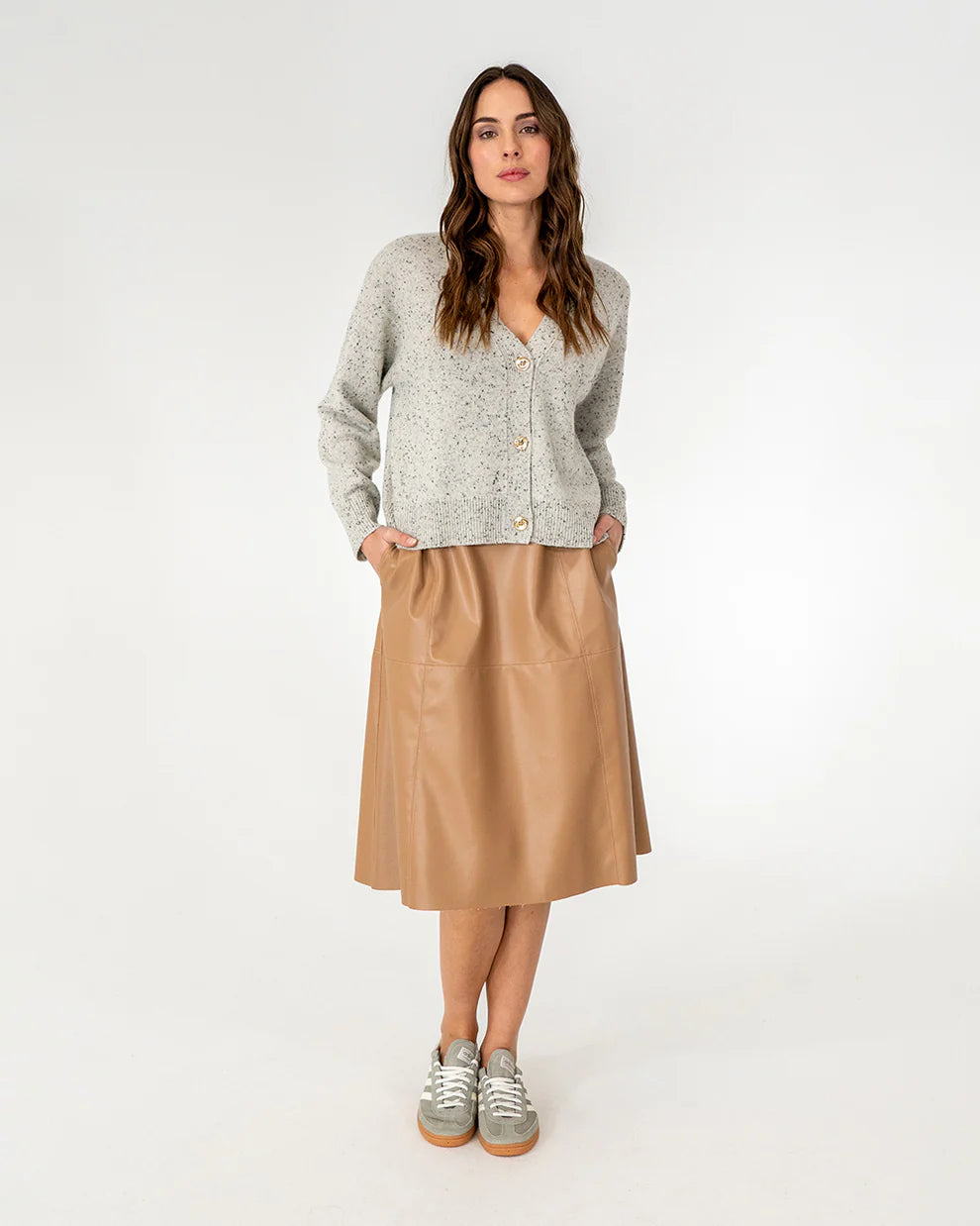 Woman wearing cardigan in strawberry and copper row skirt in tan