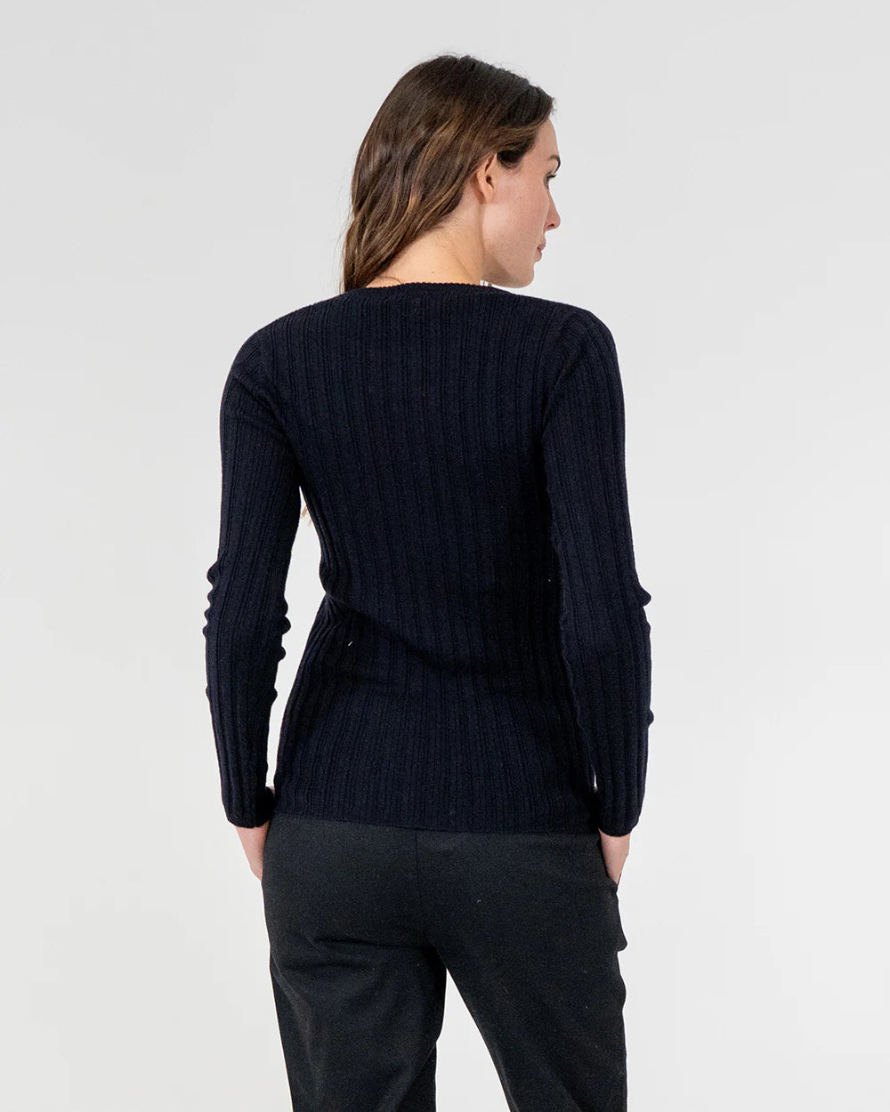 woman facing the back wearing Highton Knit Top - Navy and black bottom