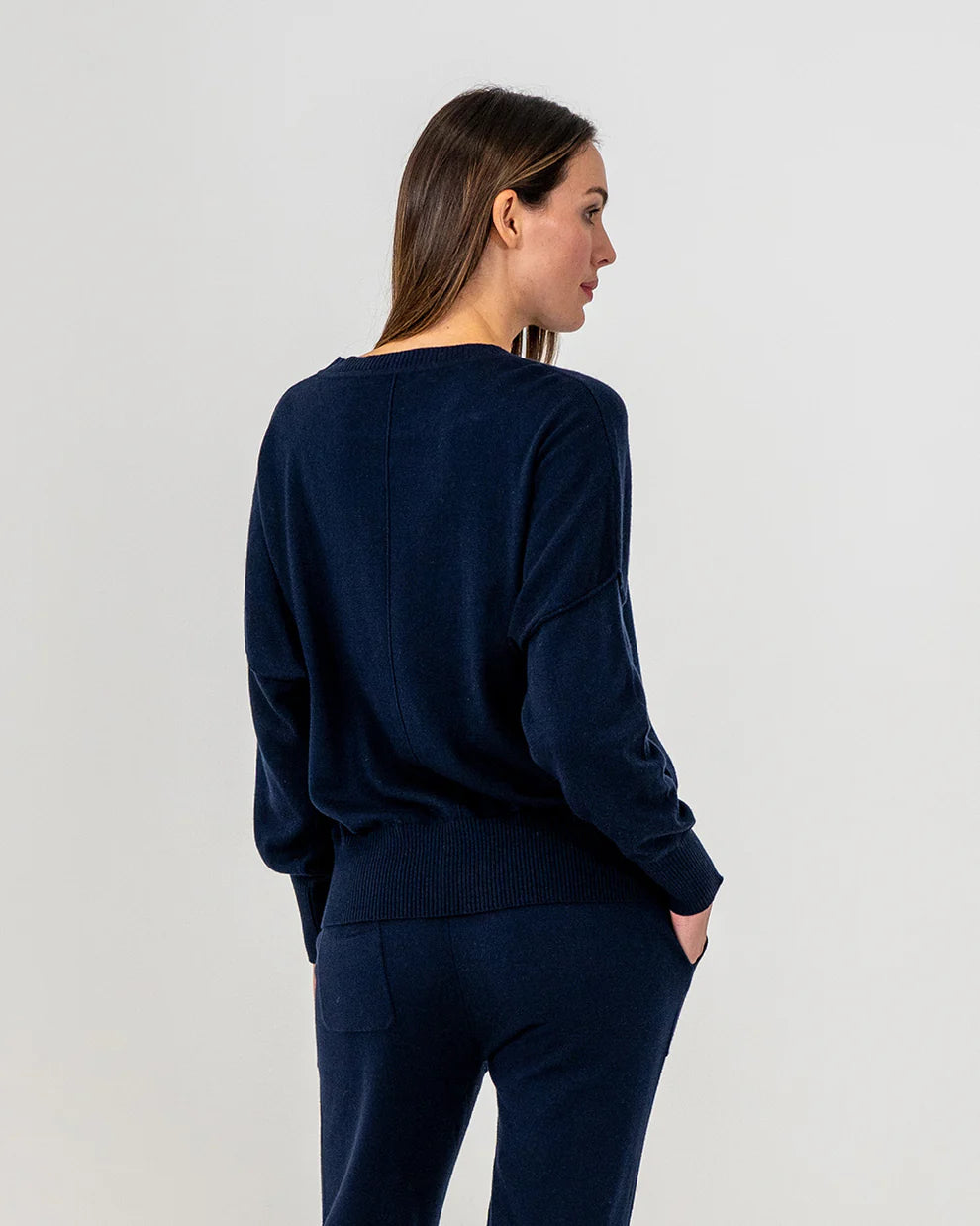 Woman wearing Lucy Knit in Navy and Track pants in navy