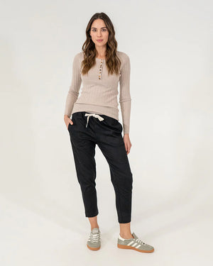 woman wearing Highton Knit Top - Natural and black bottoms