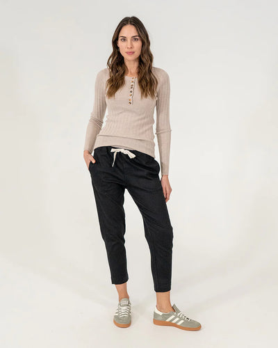 woman wearing Highton Knit Top - Natural and black bottoms