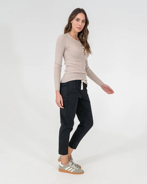 woman wearing Highton Knit Top - Natural and black bottoms