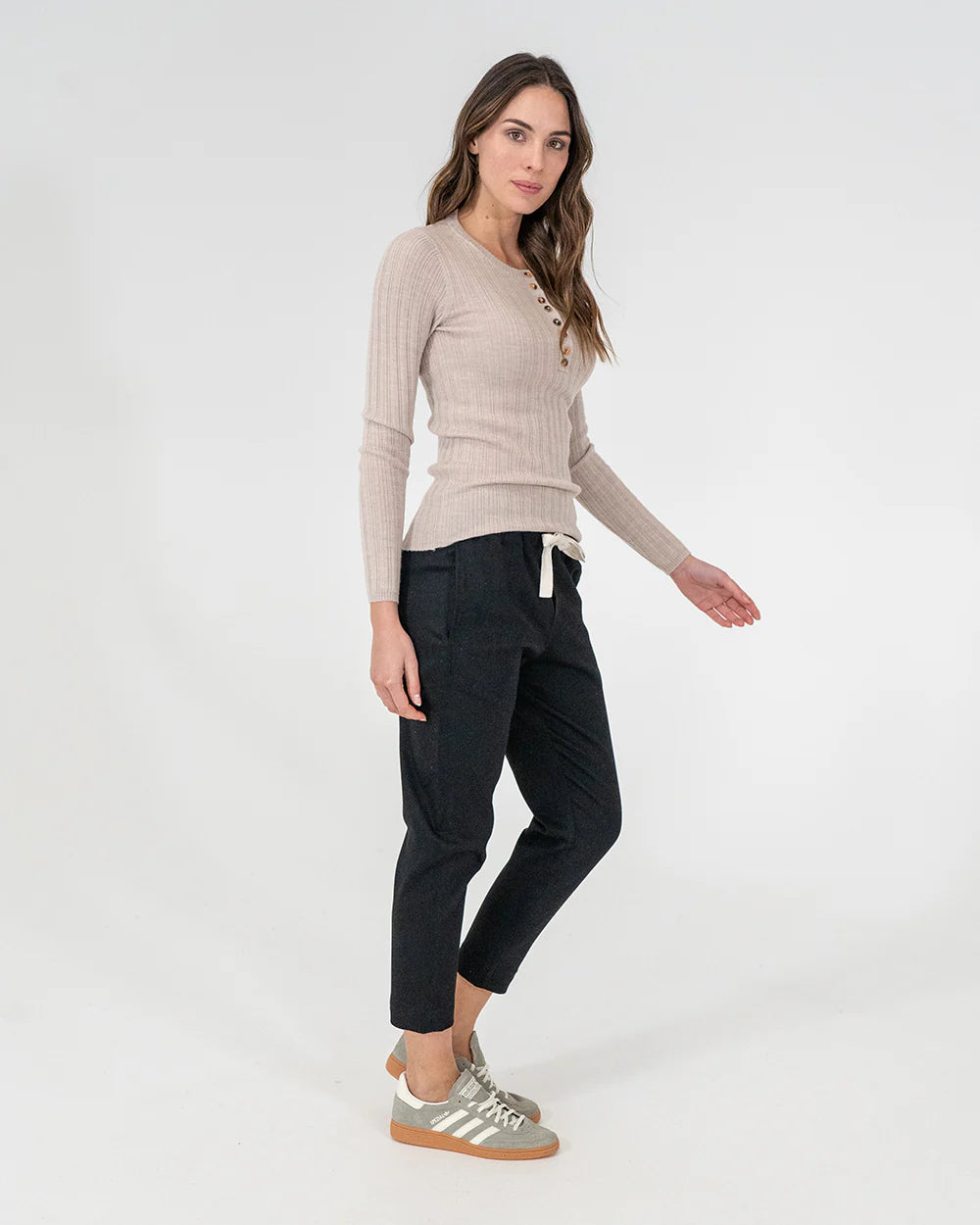 woman wearing Highton Knit Top - Natural and black bottoms