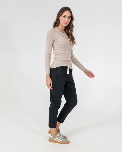 woman wearing Highton Knit Top - Natural and black bottoms