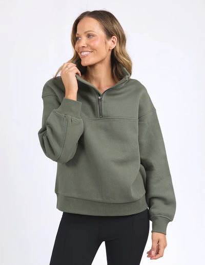 Woman wearing college zip crew khaki and black leggings