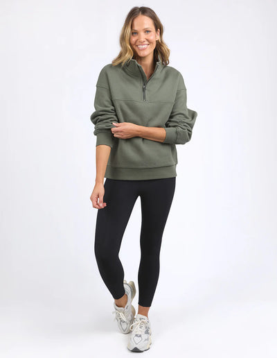 Woman wearing college zip crew khaki and black leggings