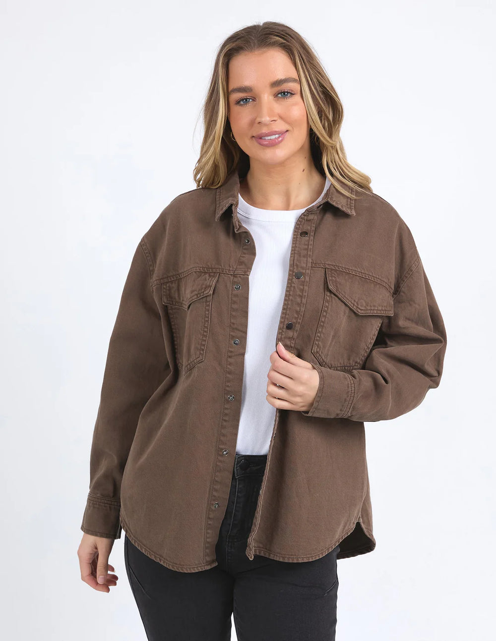 Woman seating wearing black top and pants with Daisy Overshirt - Chocolate