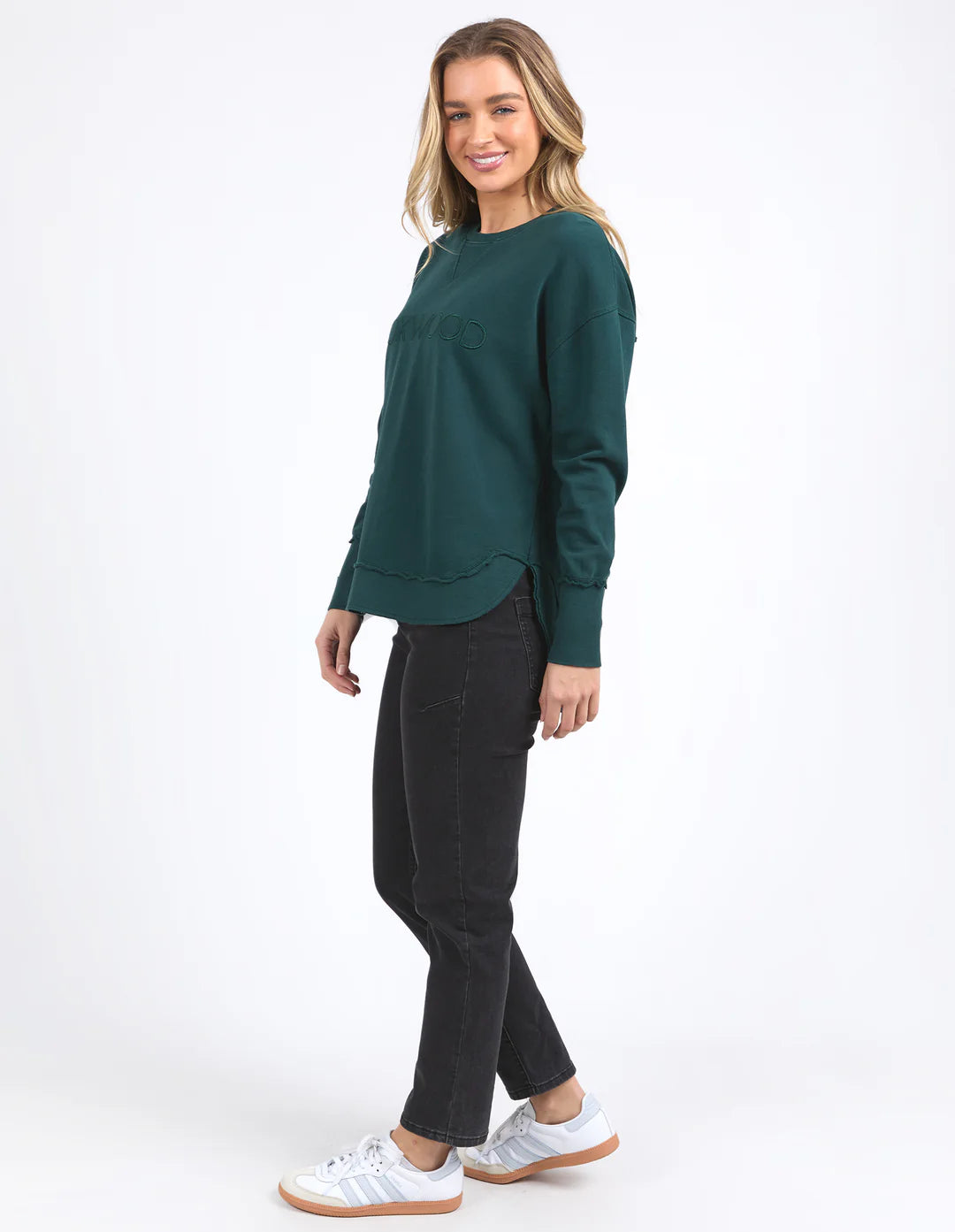Woman wearing Simplified Crew - Forest and black pants