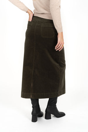 Woman facing the back wearing Tempo top in sand and Billie cord Maxi skirt in moss