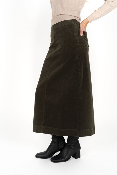Woman wearing Tempo top in sand and Billie cord Maxi skirt in moss side view