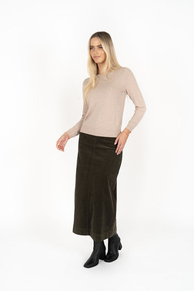 Woman wearing Tempo top in sand and Billie cord Maxi skirt in moss
