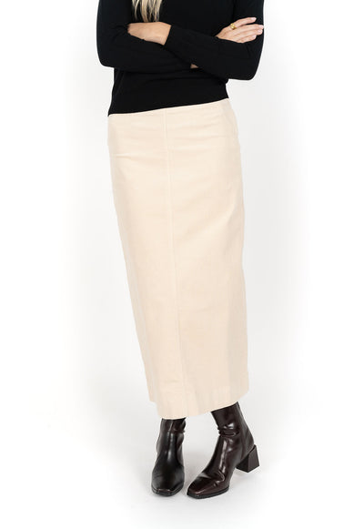 Woman wearing black long sleeve top and Billie Cord Maxi Skirt in Vanilla and black boots