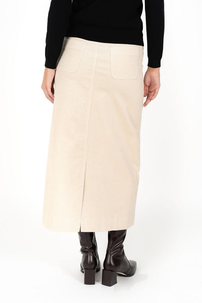 Woman looking back wearing black long sleeve top and Billie Cord Maxi Skirt in Vanilla