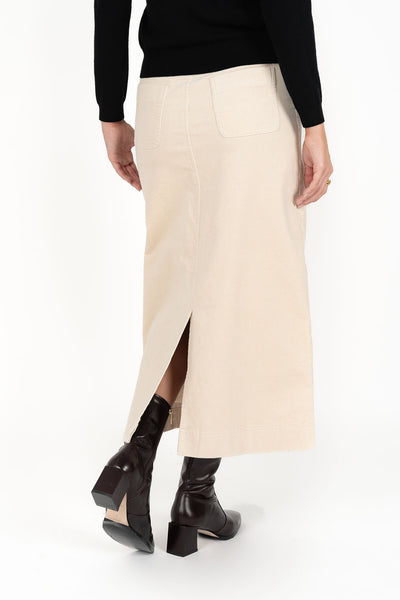 Woman looking back wearing black long sleeve top and Billie Cord Maxi Skirt in Vanilla