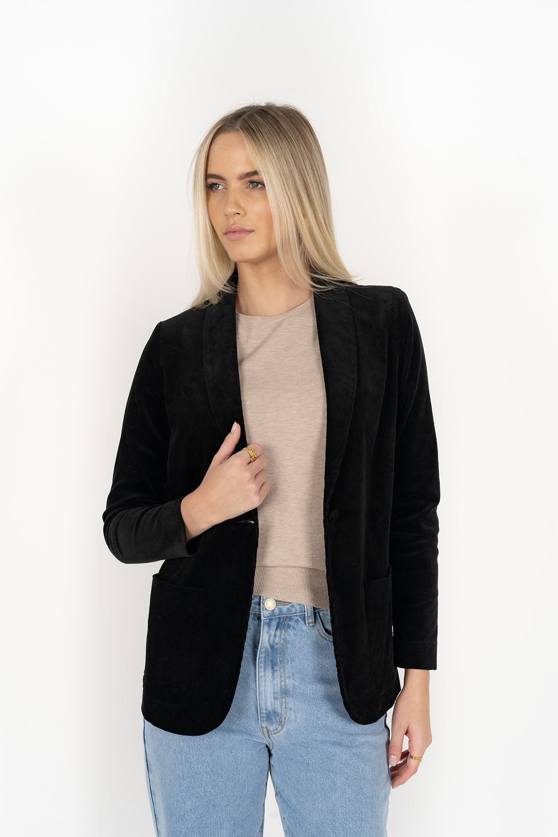 Woman wearing cream top with Blondie Jacket in Midnight and Light blue pants