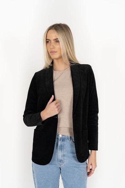Woman wearing cream top with Blondie Jacket in Midnight and Light blue pants