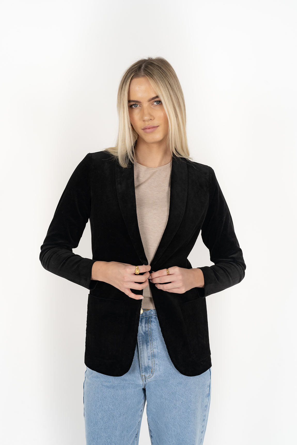 Woman wearing cream top with Blondie Jacket in Midnight and Light blue pants