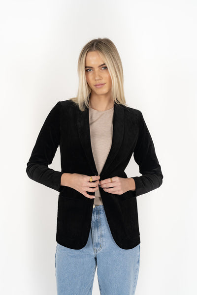 Woman wearing cream top with Blondie Jacket in Midnight and Light blue pants