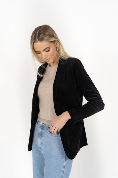 Woman wearing cream top with Blondie Jacket in Midnight and Light blue pants side view