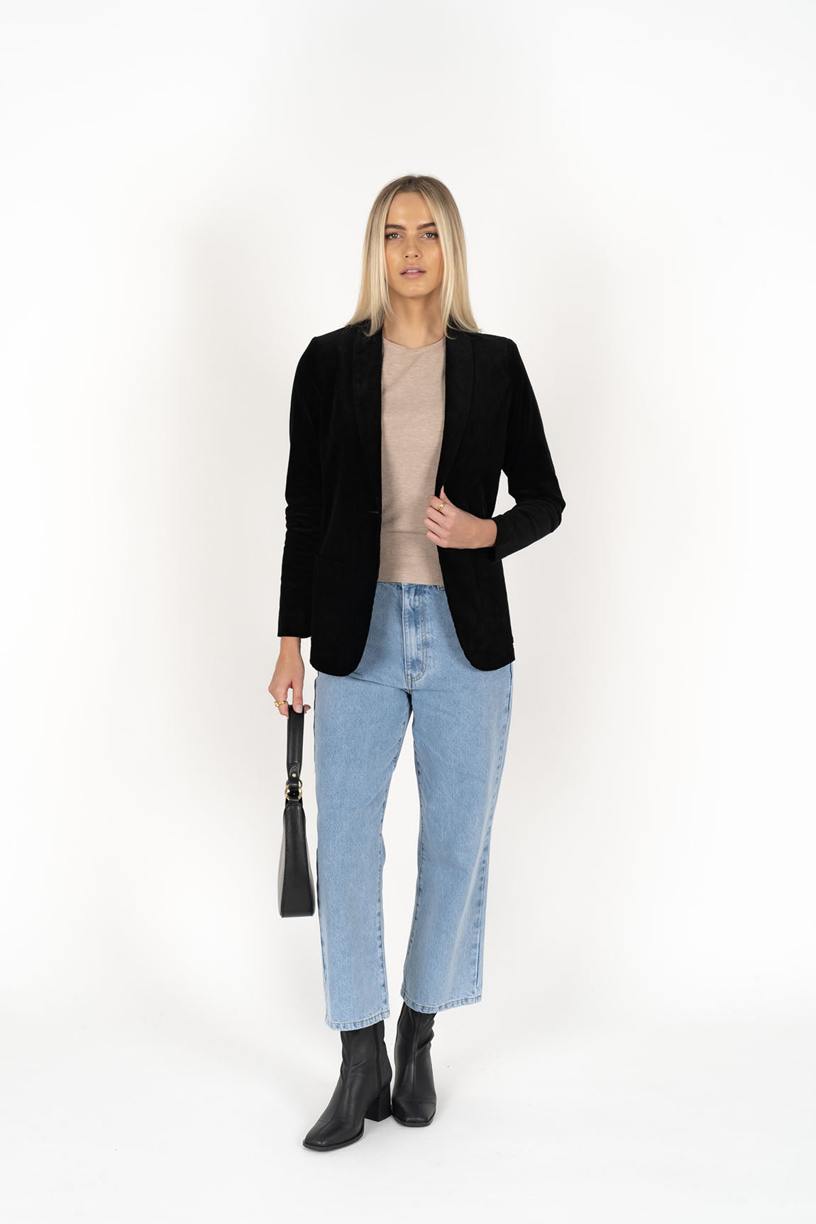 Woman wearing cream top with Blondie Jacket in Midnight and Light blue pants