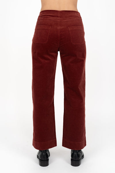 Woman wearing fleetwood cord jean in rush and black boots back view