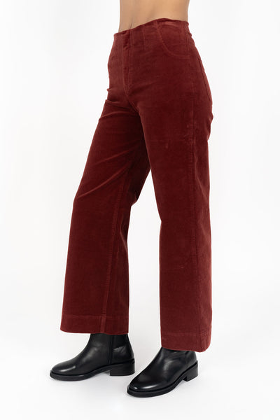 Woman wearing fleetwood cord jean in rush and black boots side view