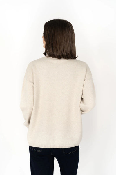 Woman facing the back wearing Knox Zip Sweater - Almond and black pants