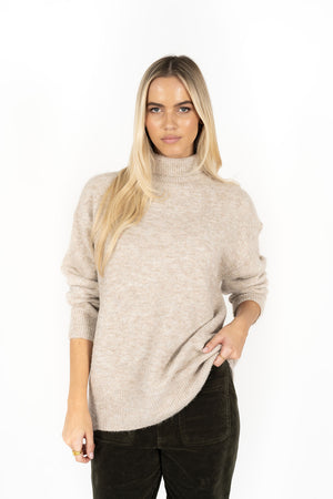 Woman wearing Presto Jumper in Oatmeal and Fleetwood Cord pants