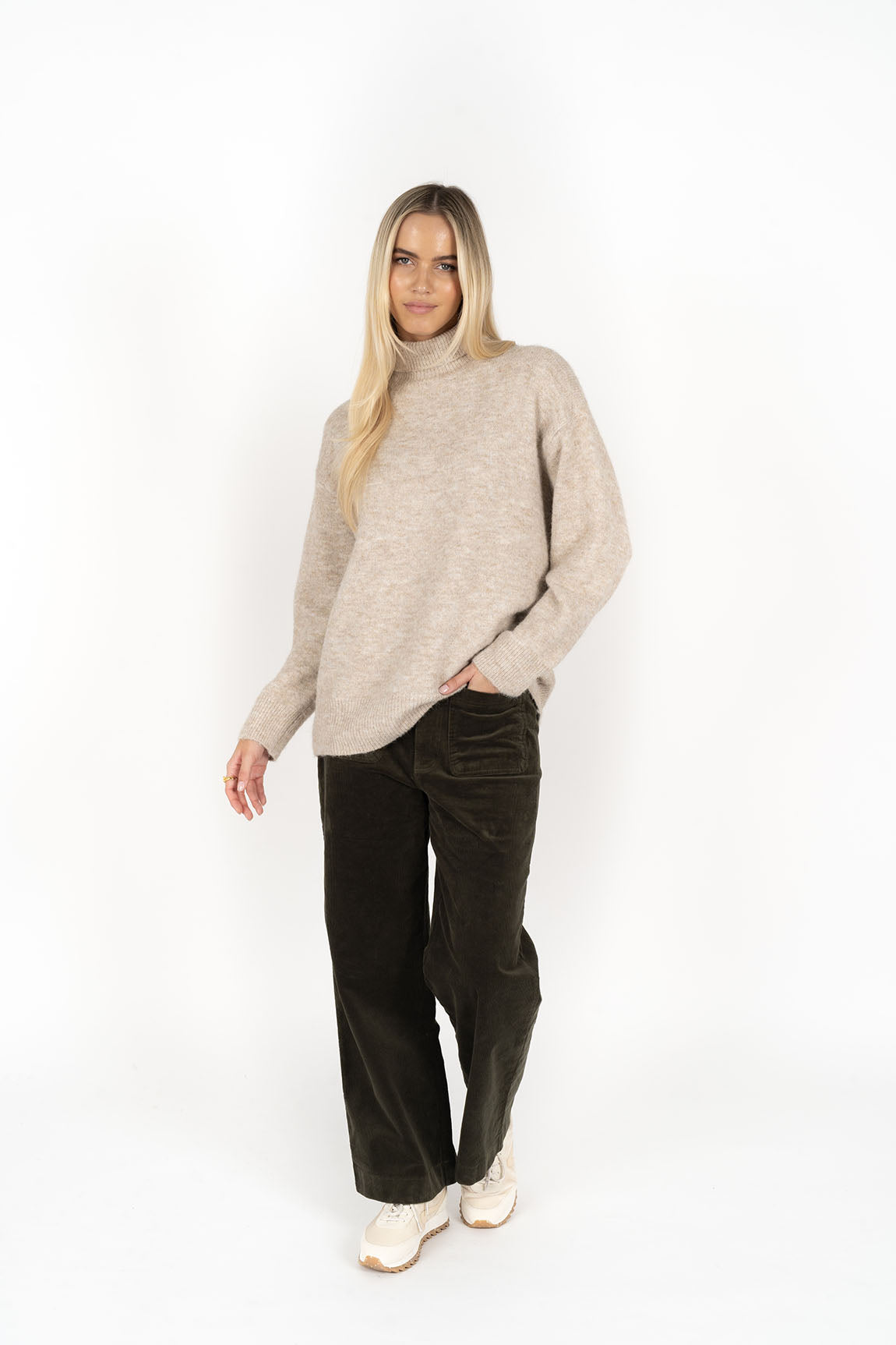 Woman wearing Presto Jumper in Oatmeal and Fleetwood Cord pants
