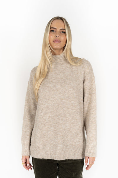 Woman wearing Presto Jumper in Oatmeal and Fleetwood Cord pants