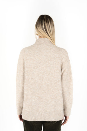 Woman facing the back wearing Presto Jumper in Oatmeal and Fleetwood Cord pants