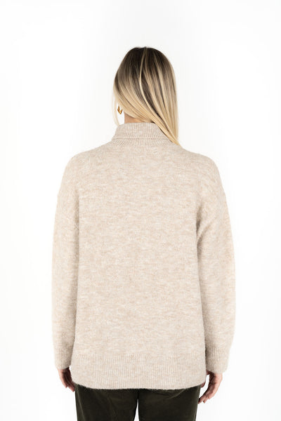 Woman facing the back wearing Presto Jumper in Oatmeal and Fleetwood Cord pants