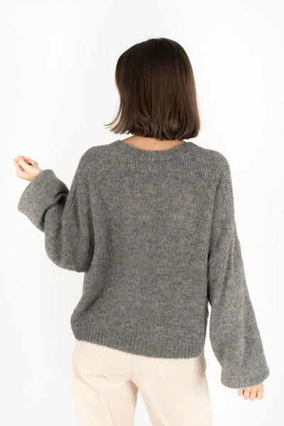 Potrait image of woman facing the back wearing Zia Jumper - Grey and pebble pants