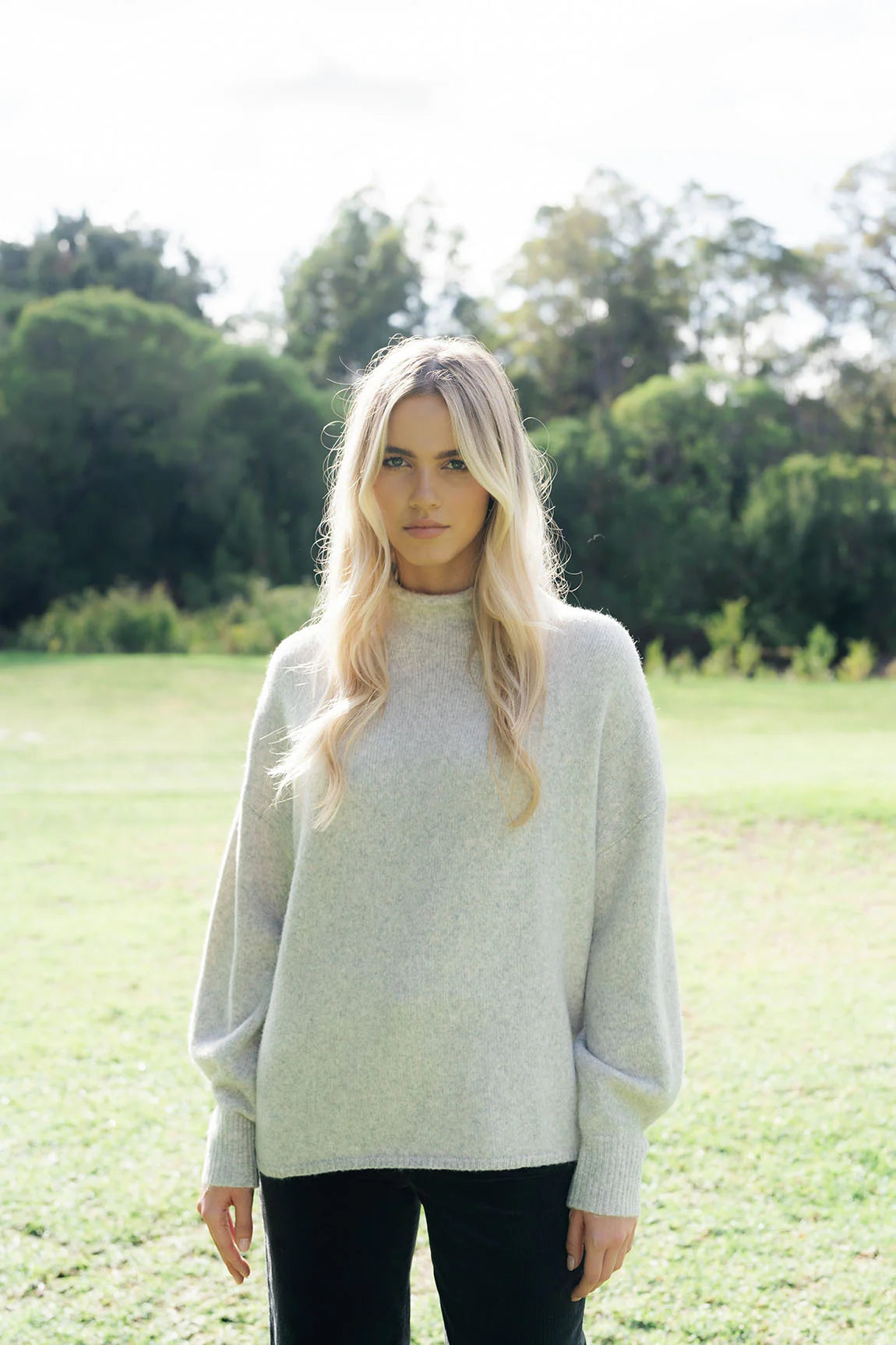 Woman wearing Chantae Jumper - Snow and black pants