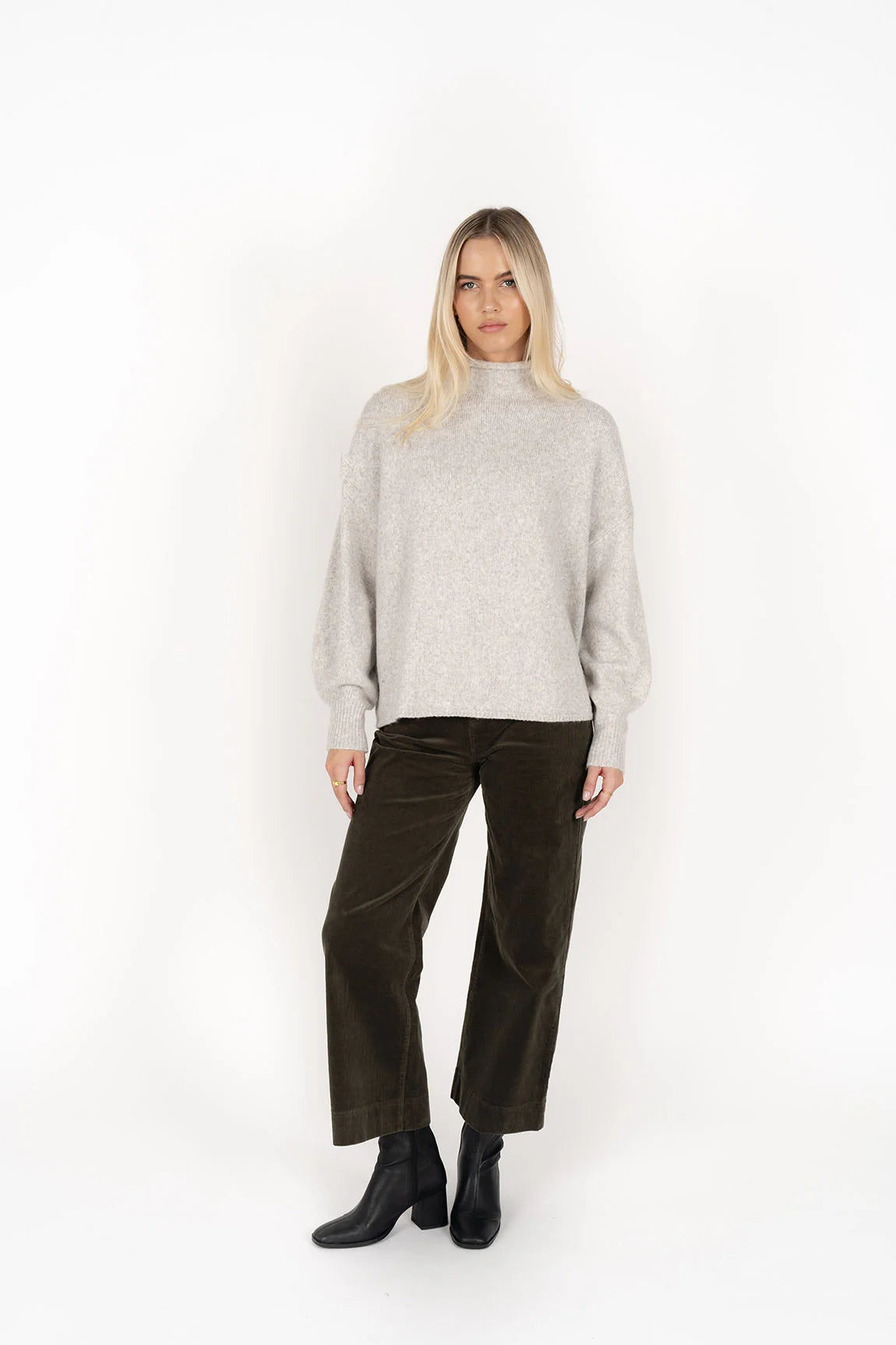 Woman wearing Chantae Jumper - Snow and black pants